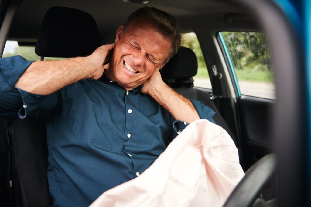 man holding his neck after a car accident injury in Rio Rico, Arizona